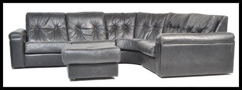 A large 20th century leather modular sofa settee upholstered in black leather to include arched