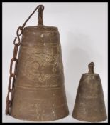 A believed 19th Century Tibetan / Chinese bronze temple bell, cast in relief with dragons standing