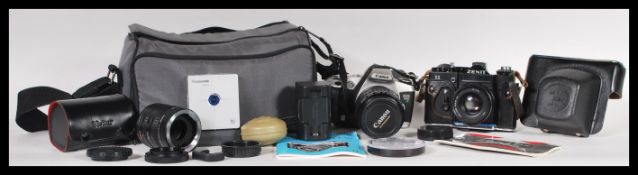 A group of vintage cameras and equipment to include a Zenit 11 camera with a Helios 44M-4 lens,