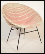 A vintage retro mid 20th century satellit chair having a pick veneer weave on a tubular black frame.