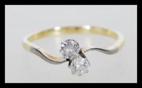 A stamped 18ct gold and platinum ring prong set with two brilliant cut diamonds.Weight 2.3g. Size
