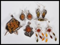A selection of amber type and silver jewellery to include a large geometric pendant set with a large