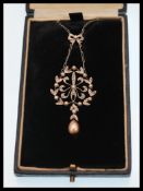 A early 20th Century Edwardian diamond and pearl garland design pendant having rose cut diamonds