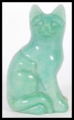 A 20th Century Chinese carved jade figurine in the form of a Cat modelled in a seated position.