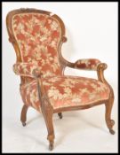 A 19th Century Victorian walnut elbow chair having a spoon back rest with button back upholstery