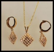 A demi parure necklace and earrings set to include a pair of hallmarked 14ct gold hoop earrings with