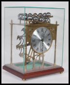A 20th century brass Falling ball clock or Spherical weight clock by Devon clocks. The clock running