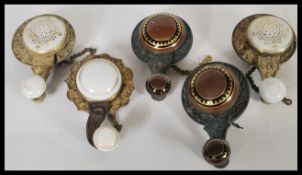 A collection of five antique Edwardian interior bell pulls having brass body and ceramic knob handle
