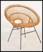 A retro 20th Century satellite sputnik atomic cane / wicker tub chair raised on ebonized tubular