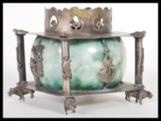 A Chinese late Qing Dynasty silver white metal censer burner raised on ox feet with four columns