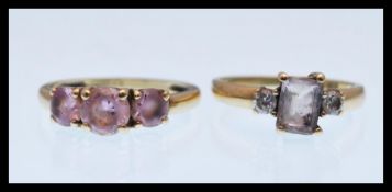 A hallmarked 9ct gold ring set with a square cut white stone with two white accent stones (