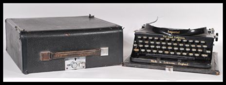 A mid 20th Century cased Imperial ' Good Companion ' travellers typewriter having yellow keys with a