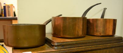 A group of three 19th century copper sauce pans / saucepans having riveted brass handles. Measures
