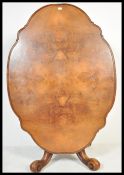 A 19th century High Victorian walnut tilt top breakfast loo table - dining table. Raised on shaped