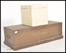 An early 20th century '' Post Rations'' brown wooden trunk having bound hinge top with swing handles