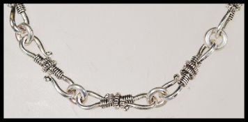 A sterling silver 925 necklace chain having an unusual fancy rope twist S hook links. Measures 18