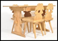 A 20th century solid pine wood country dining table raised on peg jointed lyre shaped supports