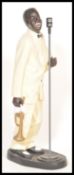 A good sized floor standing resin cast and painted figure of a negro  jazz muscian in white tuxedo