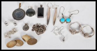 A collection of silver pendants and earrings, together with silver cufflinks and some silver chains.