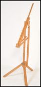 A 20th Century wooden folding artists easel of large form, raised on a tripod support. Measures: