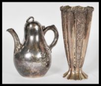 A 19th Century silver plated fluted tapering pedestal vase with chase decorated floral swags and