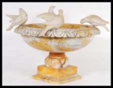 A 19th century Grand Tour alabaster centrepiece bowl / raised tazza adorned with doves to the