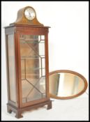 A 1930's dome top mantel clock with silvered dial together with a mahogany oval overmantel mirror