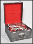 A 20th Century Stella accordion having 48 bass buttons and a 16 key keyboard having a red