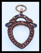 A late 18th Century Georgian gold and flat cut garnet, sapphire and split pearl glazed locket