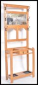 An early 20th Century Edwardian oak hall stand having two metal trays and glovebox. Twin stick
