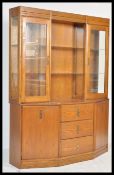 A 20th century Stag oak display cabinet sideboard of angular form. The glass bookcase cabinet raised