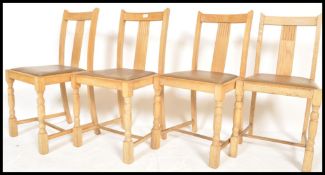 A set of 4 1930's oak dining chairs being raised on block and turned legs with drop in seats