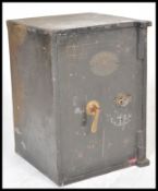 A 19th century Victorian cast iron safe having full length door makers plaque and handle to the