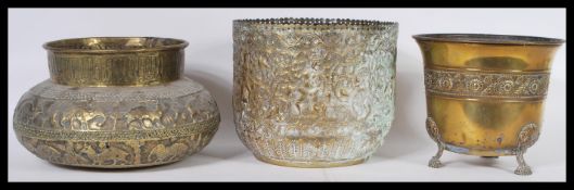 An early 20th Century Anglo Indian brass planter decorated in  relief together with another