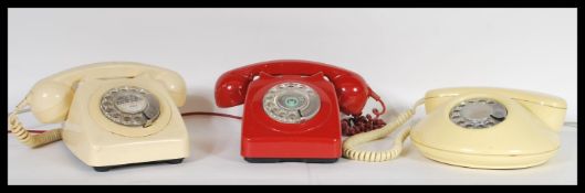 A collection of three retro 20th Century ring dial telephones to include a Northern Telecom round