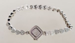 A sterling silver bracelet having heart shaped links decorated with CZ stones. Weighs 14 grams.