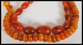 Two vintage 20th Century chinese Amber type prayer