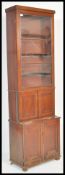 An early 19th Century Georgian tall mahogany cabinet bookcase raised on double cupboard base. The
