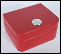 A genuine Omega faux red leather watch box having Omega plaque / badge to lid. Please note this is