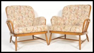 Ercol - A golden dawn Windsor pattern pair of armchairs in beech and elm having shaped  armrests and