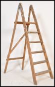 A vintage early 20th Century wooden Industrial folding step ladder. having six steps. Measures: