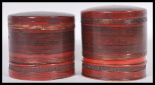 A pair of vintage 20th Century Chinese papier mache lacquered food storage pots, the cylindrical