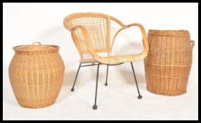 A retro 20th Century cane and whicker satellite chair raised on an ebonised metal frame together