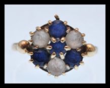 A hallmarked 9ct gold ring with a cluster of blue and white stones. Hallmarked Birmingham. Size K.5.
