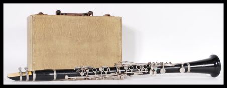 Musical Instruments. A 20th Century ebonised clarinet within a fitted handled carrying case. 69cm