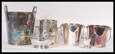 A collection of silver plate wares to include twin handled wine buckets, a spittoon, a pierced