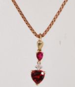 A 9ct gold necklace and pendant having a 23 inch long box link necklace chain and a diamond and ruby