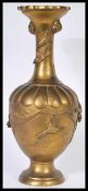 A 19th Century Japanese lamp / vase of bronze construction raised on circular base with relief