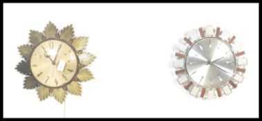 A non matching pair of retro 20th Century sunburst wall clocks both by Metamec, each with central