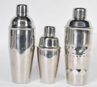 A collection of three Art Deco style silver plated sectional cocktail shakers of varying sizes